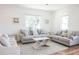 Bright living room featuring two sofas, a coffee table, and ample natural light at 116 Tidal Creek Dr., Murrells Inlet, SC 29576