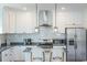 Sleek kitchen island with granite countertop and two wicker barstools at 116 Tidal Creek Dr., Murrells Inlet, SC 29576