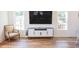 Living room with a large TV, gray media console, and an armchair at 116 Tidal Creek Dr., Murrells Inlet, SC 29576