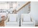 Two comfy armchairs situated near a staircase overlooking a kitchen at 116 Tidal Creek Dr., Murrells Inlet, SC 29576