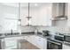 Modern kitchen showcasing white cabinets, granite countertops, and stainless steel appliances at 116 Tidal Creek Dr., Murrells Inlet, SC 29576