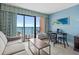Living room with ocean view, sleeper sofa, and dining table at 2207 S Ocean Blvd. # 1101, Myrtle Beach, SC 29577