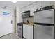 Small kitchen with microwave, stove, and refrigerator at 2207 S Ocean Blvd. # 921, Myrtle Beach, SC 29577