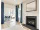 Light-filled living room with fireplace and access to a patio at 792 Indigo Bay Circle, Myrtle Beach, SC 29579