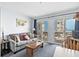 Living room with sofa and view to the balcony and ocean at 920 N Waccamaw Dr. # 2106, Garden City Beach, SC 29576