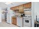 Efficient kitchen with wood cabinets and white appliances at 920 N Waccamaw Dr. # 2106, Garden City Beach, SC 29576