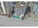 Aerial view of building, pool, and beach access at 920 N Waccamaw Dr. # 2106, Garden City Beach, SC 29576