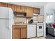 Clean kitchen, featuring white appliances and wood cabinets at 920 N Waccamaw Dr. # 2106, Garden City Beach, SC 29576