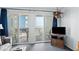 Living room with sliding doors to balcony and ocean view at 920 N Waccamaw Dr. # 2106, Garden City Beach, SC 29576