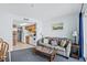 Living room with kitchen view, sofa, and coffee table at 920 N Waccamaw Dr. # 2106, Garden City Beach, SC 29576
