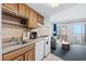 Open kitchen with ocean view, offering white appliances and wood cabinets at 920 N Waccamaw Dr. # 2106, Garden City Beach, SC 29576
