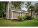 Beige house with gray roof, landscaping, and a screened porch at 2405 Bert Dr., North Myrtle Beach, SC 29582