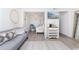 Living area with gray couch, view into bedroom, and wine rack at 9400 Shore Dr. # 308, Myrtle Beach, SC 29572