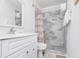 Clean bathroom with a shower/tub combo, white vanity, and gray tile walls at 9400 Shore Dr. # 308, Myrtle Beach, SC 29572