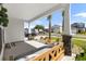 Covered front porch with a wooden bench and landscaping at 1087 Saltgrass Way, Myrtle Beach, SC 29588