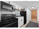 Full kitchen with black appliances and white cabinets at 9550 Shore Dr. # 224, Myrtle Beach, SC 29572