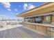 Outdoor bar area with wooden counters and white plastic tables and chairs at 9550 Shore Dr. # 224, Myrtle Beach, SC 29572