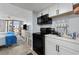 Compact kitchen with black appliances and white cabinets at 9550 Shore Dr. # 224, Myrtle Beach, SC 29572