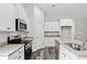Modern kitchen with white cabinets, granite countertops, and stainless steel appliances at 137 Six Mile Creek Dr., Georgetown, SC 29440