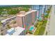 Aerial view of oceanfront high-rise building with pool and beach access at 2207 S Ocean Blvd. # 414, Myrtle Beach, SC 29577