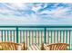 Balcony view of the beach with chairs at 2207 S Ocean Blvd. # 915, Myrtle Beach, SC 29577