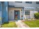 Townhouse entrance with a red door and landscaping at 775 Plantation Dr. # 88, Little River, SC 29566