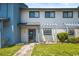 Front view of a light blue and white townhouse with a landscaped yard at 775 Plantation Dr. # 88, Little River, SC 29566