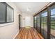 Bright sunroom with light wood floors, sliding doors, and a ceiling fan at 775 Plantation Dr. # 88, Little River, SC 29566