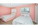 Two twin beds in a cozy bedroom with pink walls at 775 Plantation Dr. # 88, Little River, SC 29566