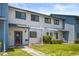 Front view of a light blue and white townhouse with a landscaped yard at 775 Plantation Dr. # 88, Little River, SC 29566