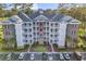Brick building exterior with balconies and ample parking at 4874 Luster Leaf Circle # 304, Myrtle Beach, SC 29577