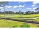 Green golf course with walking path and lush landscape at 4874 Luster Leaf Circle # 304, Myrtle Beach, SC 29577