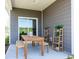 Covered patio with wooden table, benches, and potted plants at 4133 Bayhill St., Myrtle Beach, SC 29579