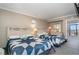Bedroom with two twin beds and access to balcony at 6900 N Ocean Blvd. # 910, Myrtle Beach, SC 29572