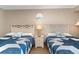 Bedroom with two twin beds and nautical-themed decor at 6900 N Ocean Blvd. # 910, Myrtle Beach, SC 29572