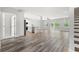 Open floor plan living area with kitchen, hardwood floors, and sliding doors at 16 Mullet Bay Rd, Pawleys Island, SC 29585
