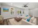 Bright living room with comfy sofas, large windows, and access to a deck at 16 Mullet Bay Rd, Pawleys Island, SC 29585