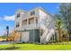 Two-story home with white siding, gray accents, and a detached garage at 16 Mullet Bay Rd, Pawleys Island, SC 29585