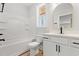 Bathroom features a white vanity, bathtub, and a window for natural light at 16 Mullet Bay Rd, Pawleys Island, SC 29585