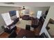 Spacious living room with leather furniture, hardwood floors, and a large TV at 5226 Highway 17 Business, Murrells Inlet, SC 29576