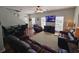 Spacious living room featuring leather sofas, a large TV, and hardwood floors at 5226 Highway 17 Business, Murrells Inlet, SC 29576
