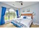Spacious bedroom with large windows, plush bed, and wood dresser at 4789 Wild Iris Dr. # 203, Myrtle Beach, SC 29577