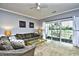 Bright living room with golf course view, sliding glass doors, and comfy seating at 4789 Wild Iris Dr. # 203, Myrtle Beach, SC 29577
