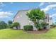Gray siding building with landscaping and pond at 8725 Chandler Dr. # F, Surfside Beach, SC 29575