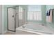 Bathroom featuring a bathtub, shower, and window at 1433 Beaumont Way, Myrtle Beach, SC 29577