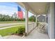 Covered front porch with white railings and American flag at 1433 Beaumont Way, Myrtle Beach, SC 29577