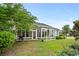 Home exterior showcasing a sunroom and landscaped yard at 1433 Beaumont Way, Myrtle Beach, SC 29577
