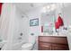 Neat bathroom with tub, toilet and wood vanity at 1433 Beaumont Way, Myrtle Beach, SC 29577