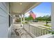 Relaxing front porch with two chairs and an American flag at 1433 Beaumont Way, Myrtle Beach, SC 29577