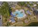 Aerial view of community pool with lounge chairs and surrounding landscape at 1433 Beaumont Way, Myrtle Beach, SC 29577